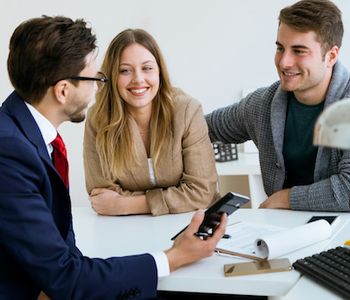 Couple discussing VA loan eligibility with mortgage lender.