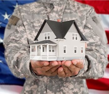 Military holding VA Home Loan concept in hand.