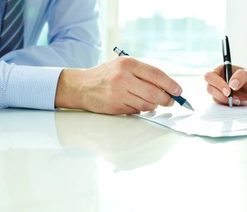 Signing document for VA loan application.