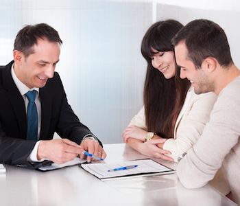 Couple signing VA Loan documents.