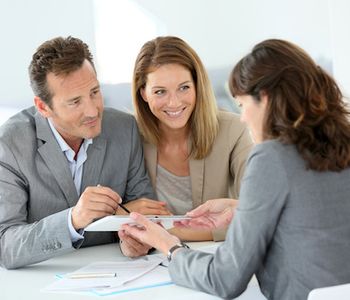 Couple discussing VA Loan with mortgage lender.