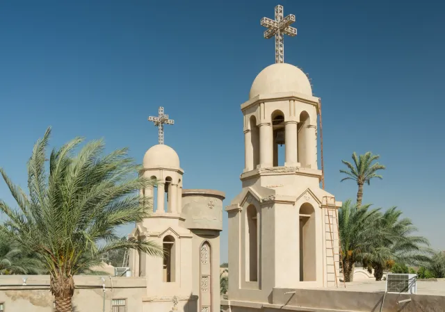 Palm trees and the cross-topped towers of Baramous Monastery in 2012.