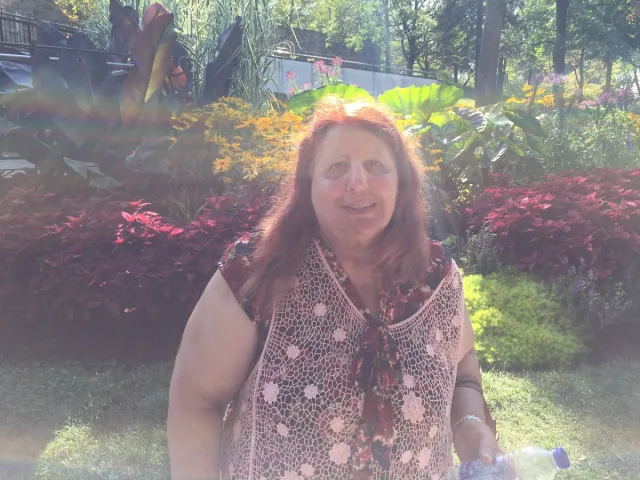 A traveler among flowers and greenery at Mount Royal.