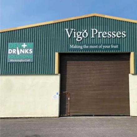 Green and white branded warehouse, with the same coloured-themed signage.