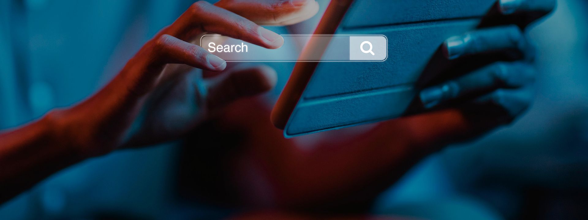A person's hands hold a smartphone displaying a prominent search bar on its screen, with a search icon on the right, symbolising a Google Business Listing or a local search query.