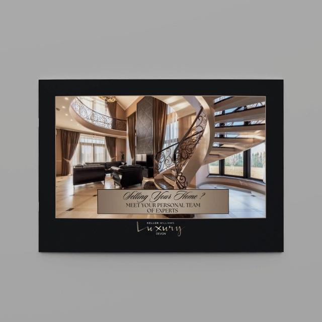 Luxury brochure showing home interior with grand spiral staircase