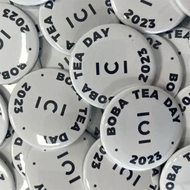 White branded cup badges, with black text