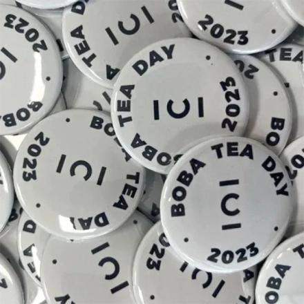 White branded cup badges, with black text