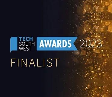The image features a "FINALIST" announcement for the "Tech South West Awards 2023" on a dark background. The left side is dark blue, transitioning to a sparkling gold effect on the right. The logo "TECH SOUTH WEST" is in a blue speech bubble, connected to a blue banner with "AWARDS" in white, and "2023" in white next to it. Below, "FINALIST" is written in gold.
