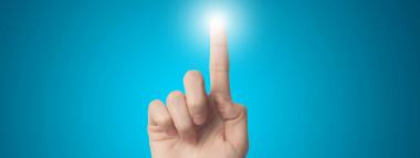 A hand with an index finger extended upwards, pointing towards a bright, glowing light against a vibrant blue background, symbolising interaction, activation, or reaching a goal in Meta PPC advertising