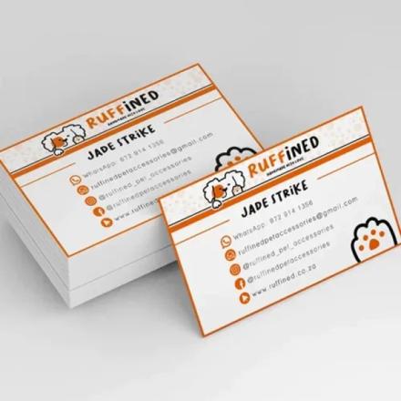 White business cards with black text and orange trim. 