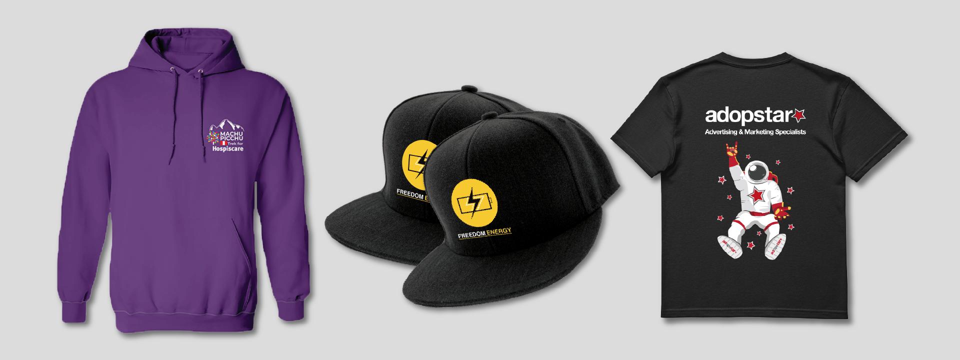 A purple hoodie with a small logo on the chest, two black baseball caps with a yellow lightning bolt logo, and a black t-shirt with a graphic of an astronaut and 'adopstar' branding, all displayed against a grey background showcasing our branding clothing design.