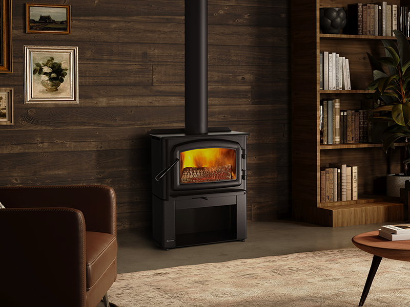 A modern wood stove with a fire burning sits in a cozy living room.