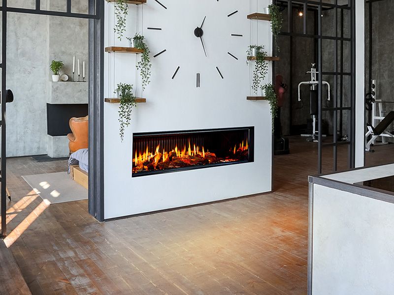 Modern living room with modern DaVinci fireplace, large clock, and gym equipment.