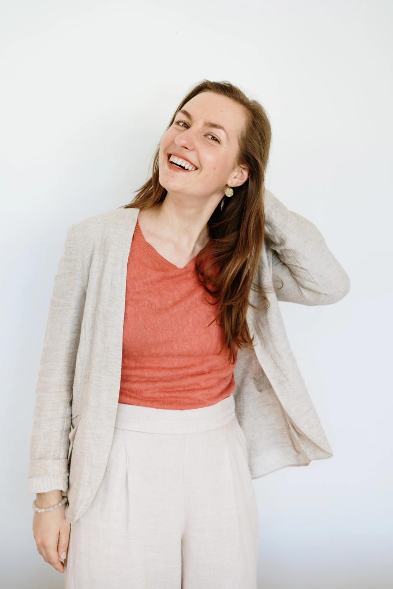 Maja Herrero portrait, smiling warmly with a beaded necklace