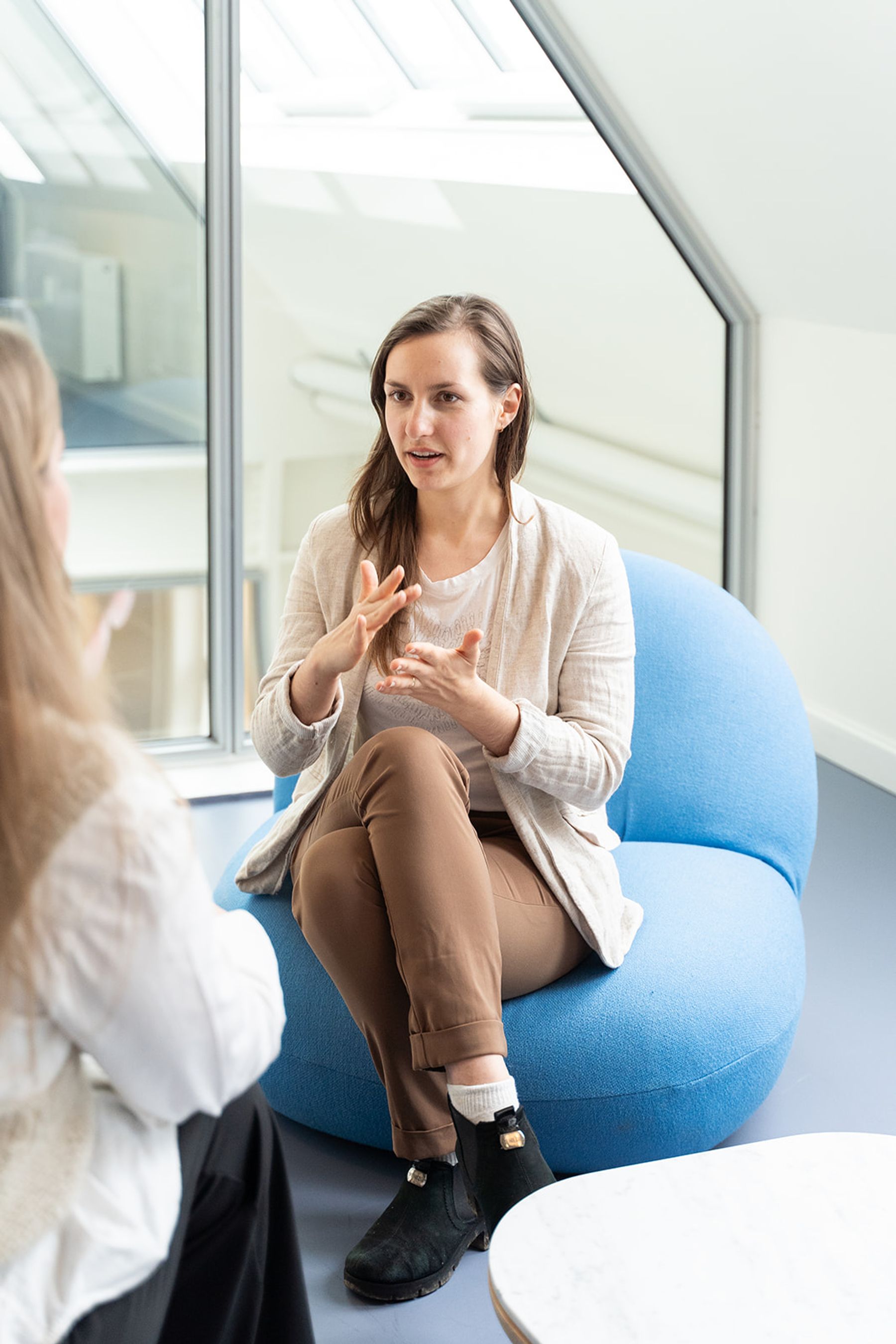 Maja coaching a client in conversation, gesturing expressively