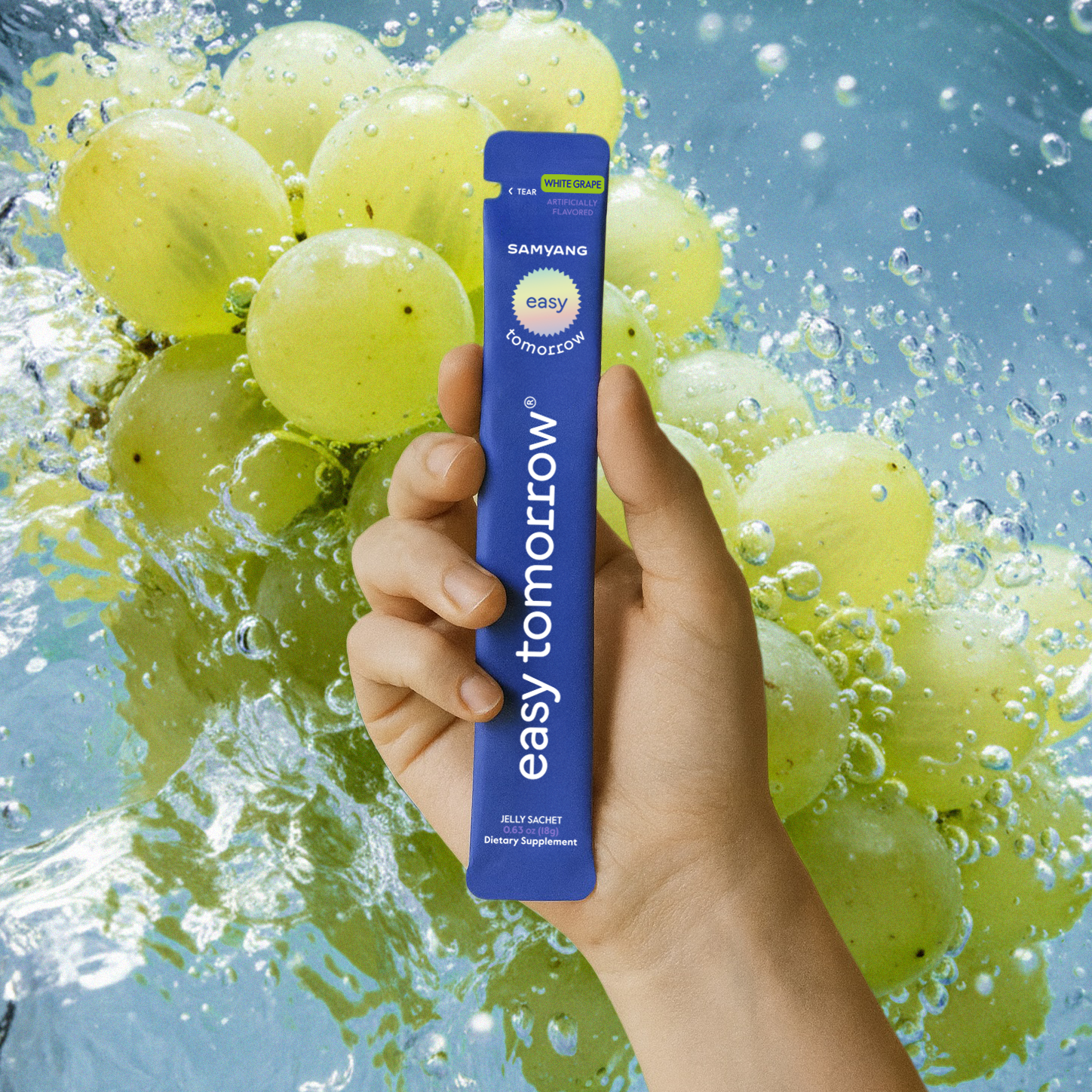 A hand holding a grape-flavored Easy Tomorrow sachet.