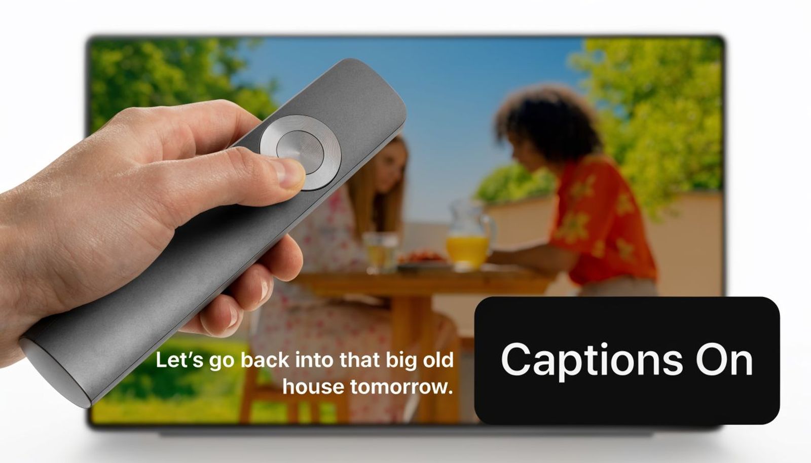 A hand holding a remote control pointing at a television screen showing subtitles and a captions on indicator.
