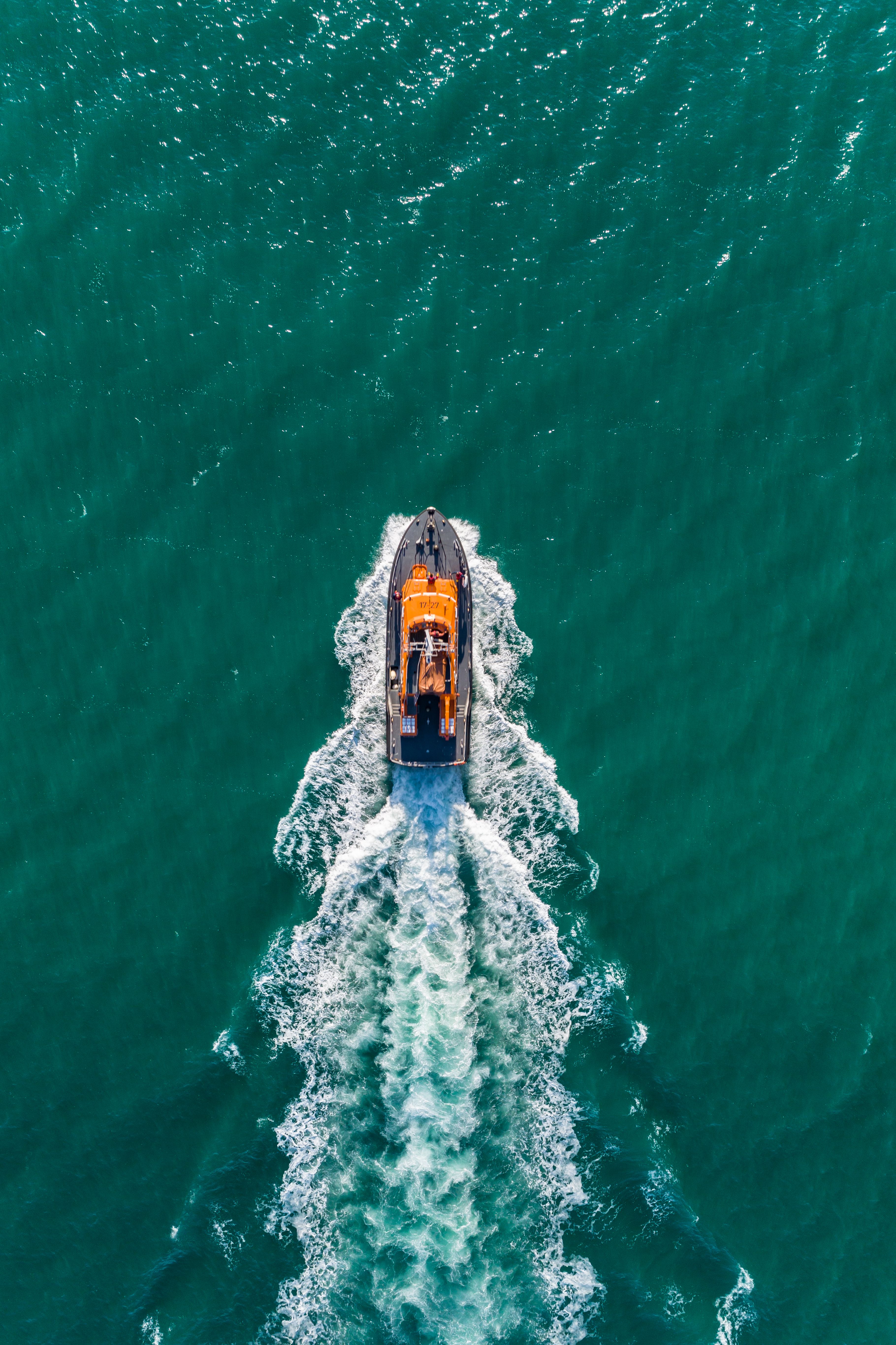 An aerial view of the lifeboat sailing through tranquil seas, Cornwall