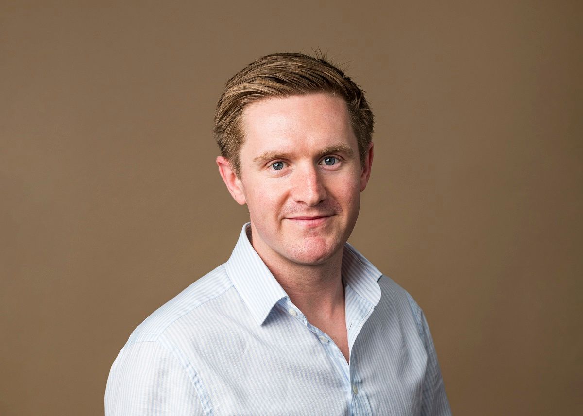 A photo of Jonty Brooks with a colorama backdrop