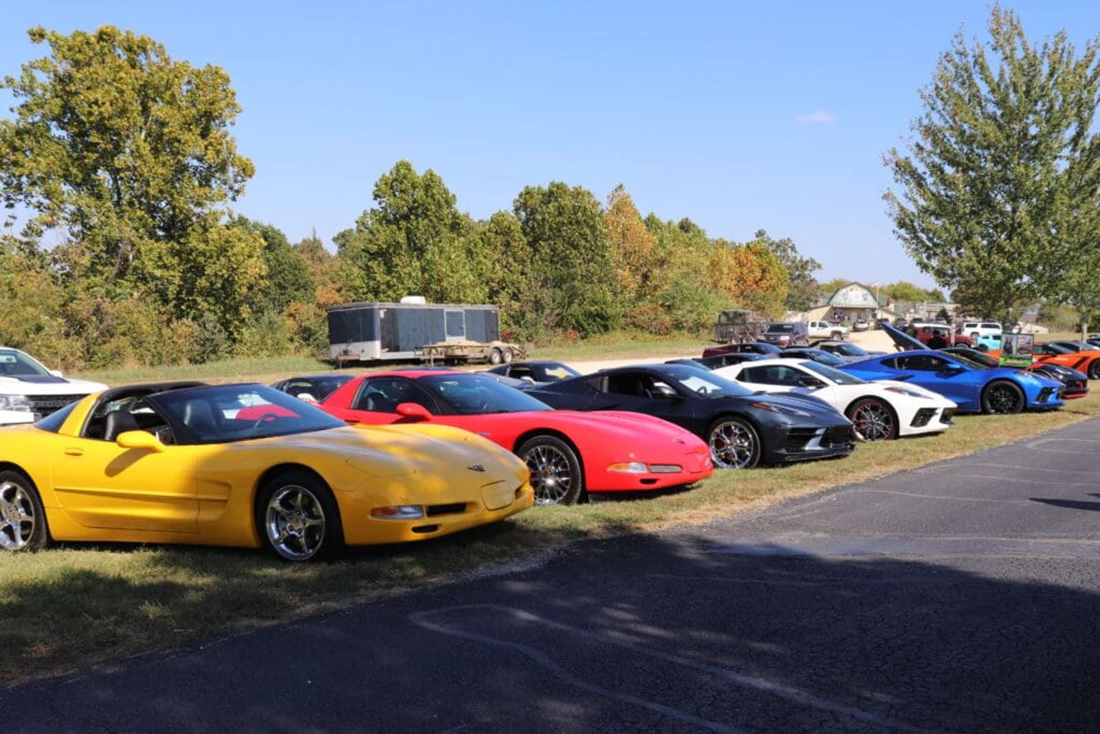 A line of Corvettes from several generations parked on the grass outside Eureka Springs during Corvette Weekend