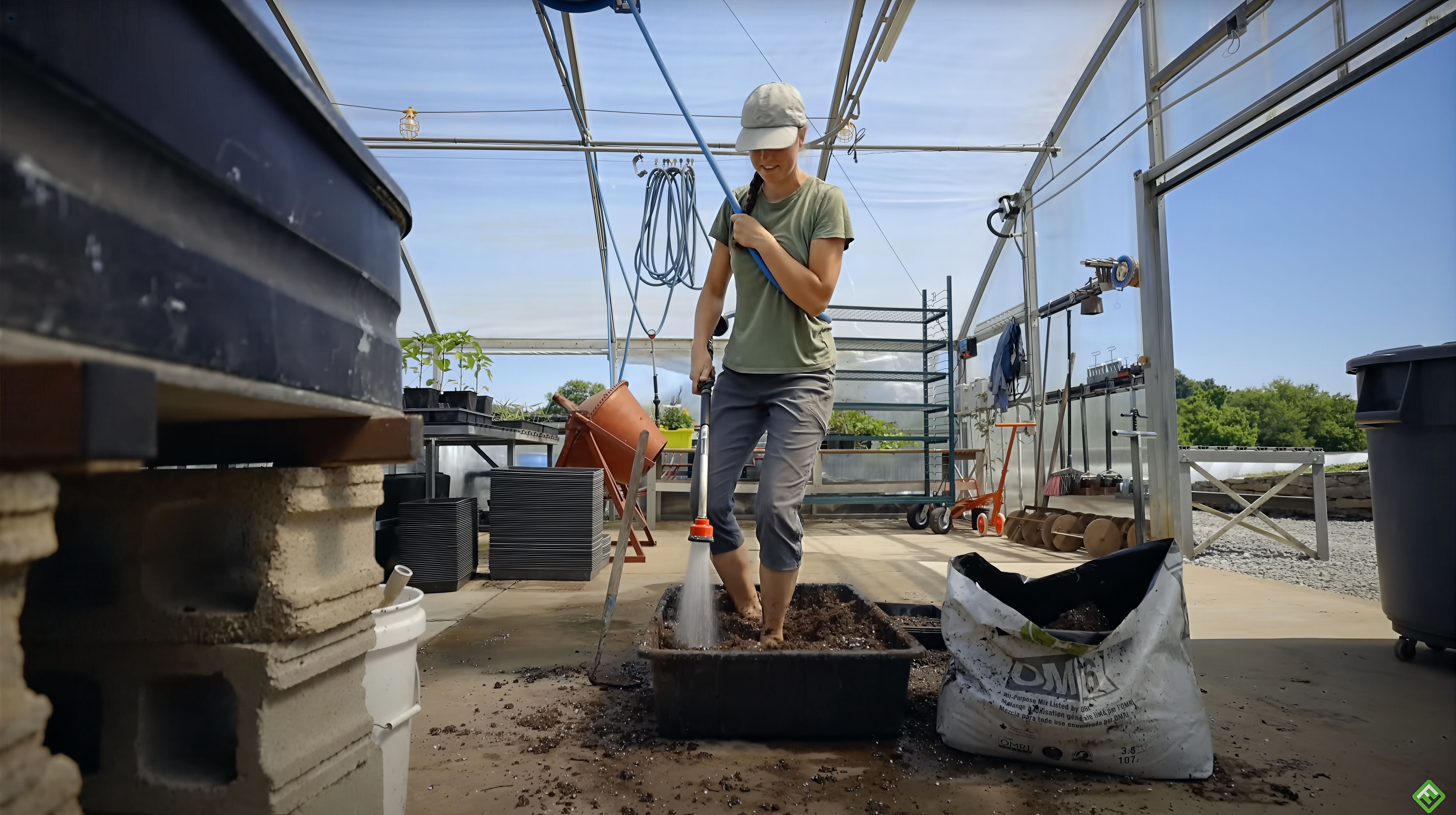 Mixing potting soil with water to make soil blocks for planting transplants.