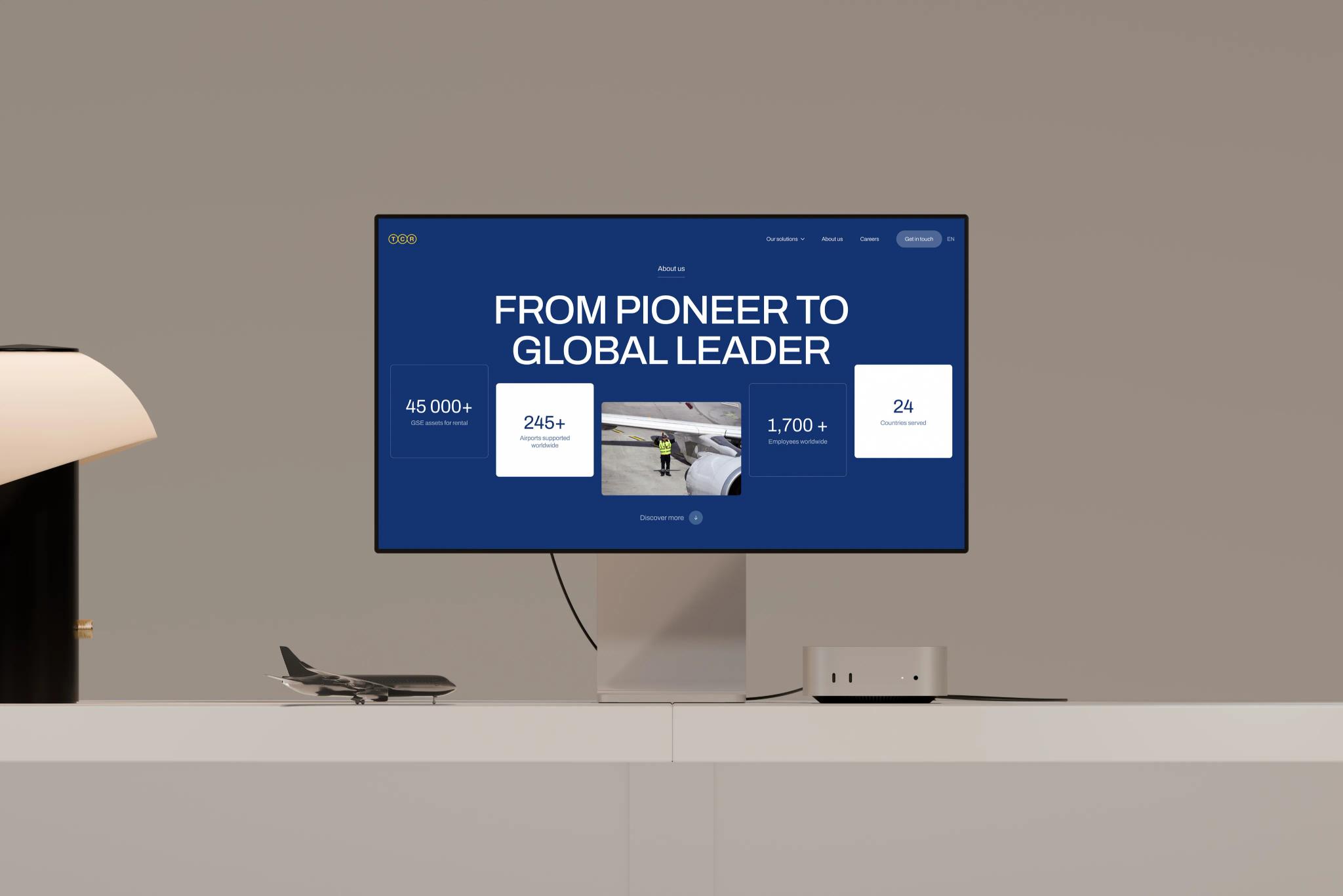 Macbook mockup of the TCR Group website