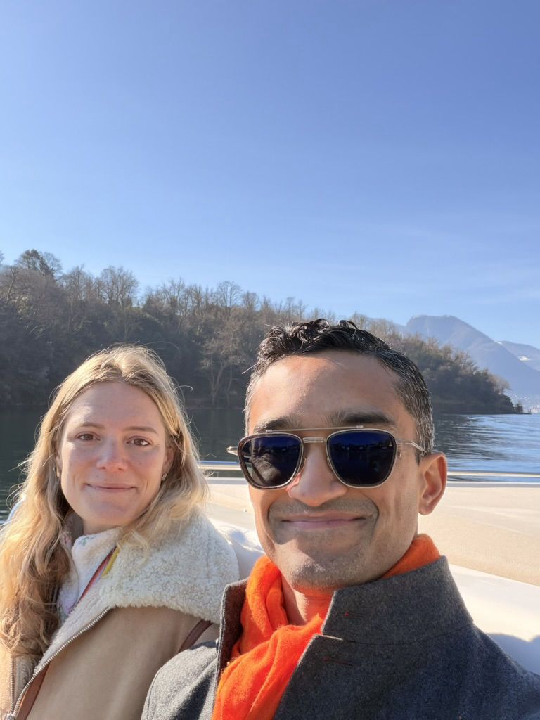 Daniel and Alex on a boat on a sunny alpine lake