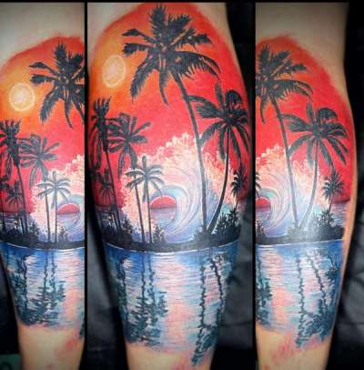 Colorful tropical beach scene tattoo on calf