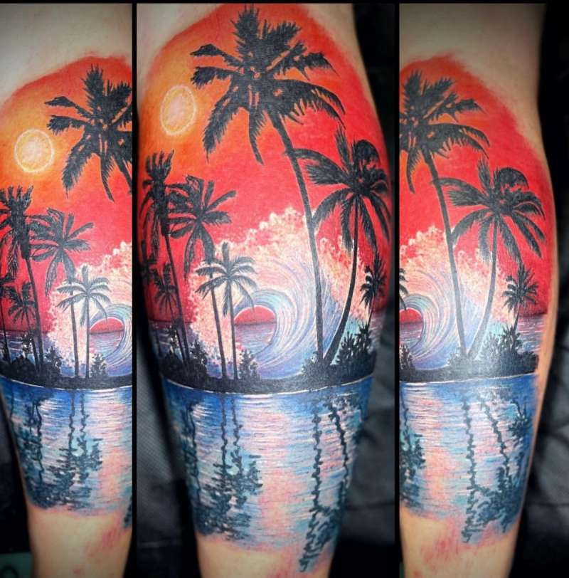 Colorful tropical beach scene tattoo on calf