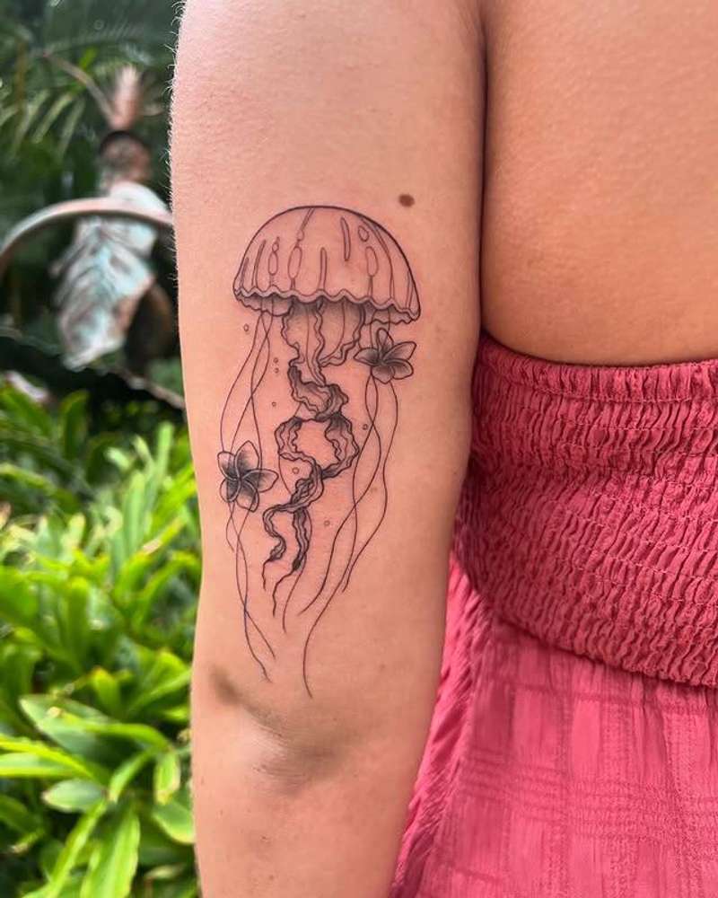 Black and grey fine line jellyfish tattoo on upper arm