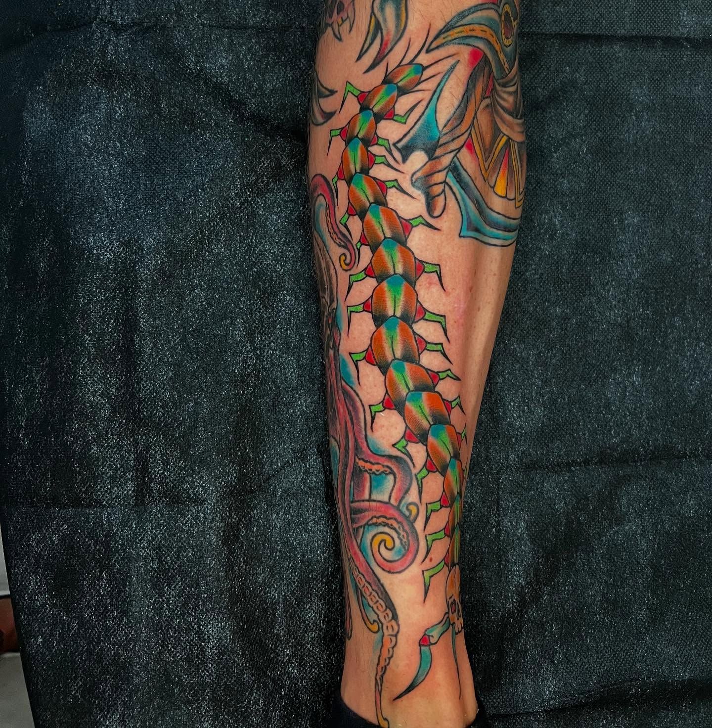 Colorful neo traditional centipede tattoo on calf