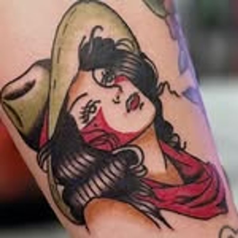 neotraditional tattoo of a cowgirl on an arm