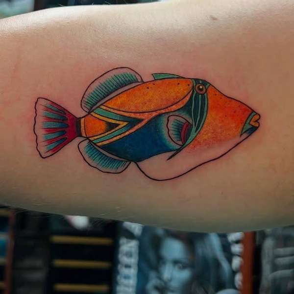 colorful fish tattoo on upper arm