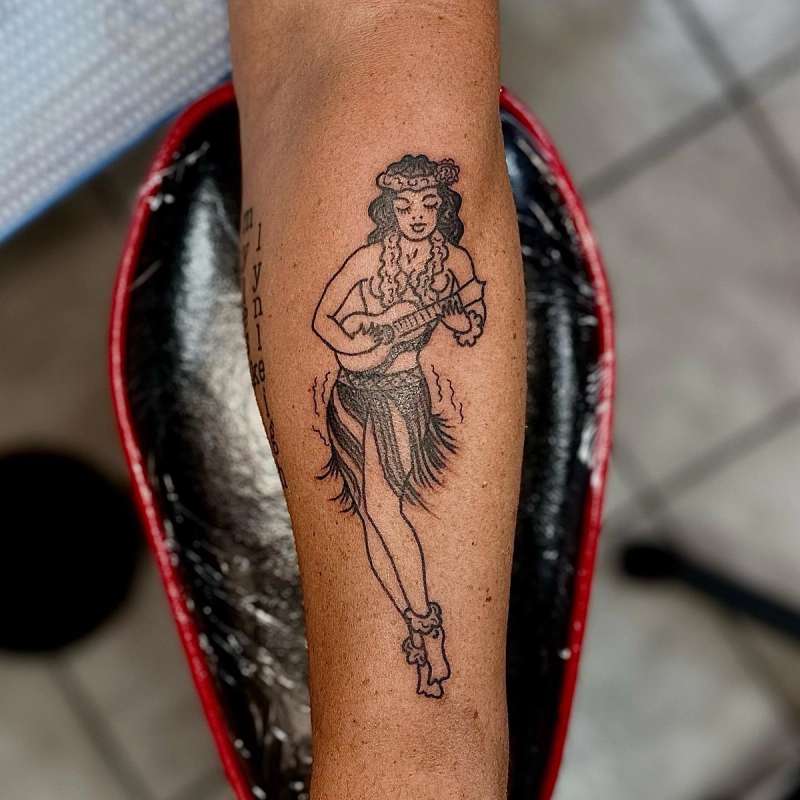 american traditional hula girl tattoo on forearm.