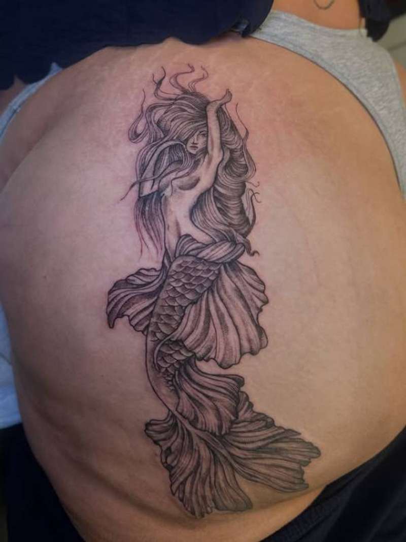 Black and grey illustrative mermaid tattoo on upper back