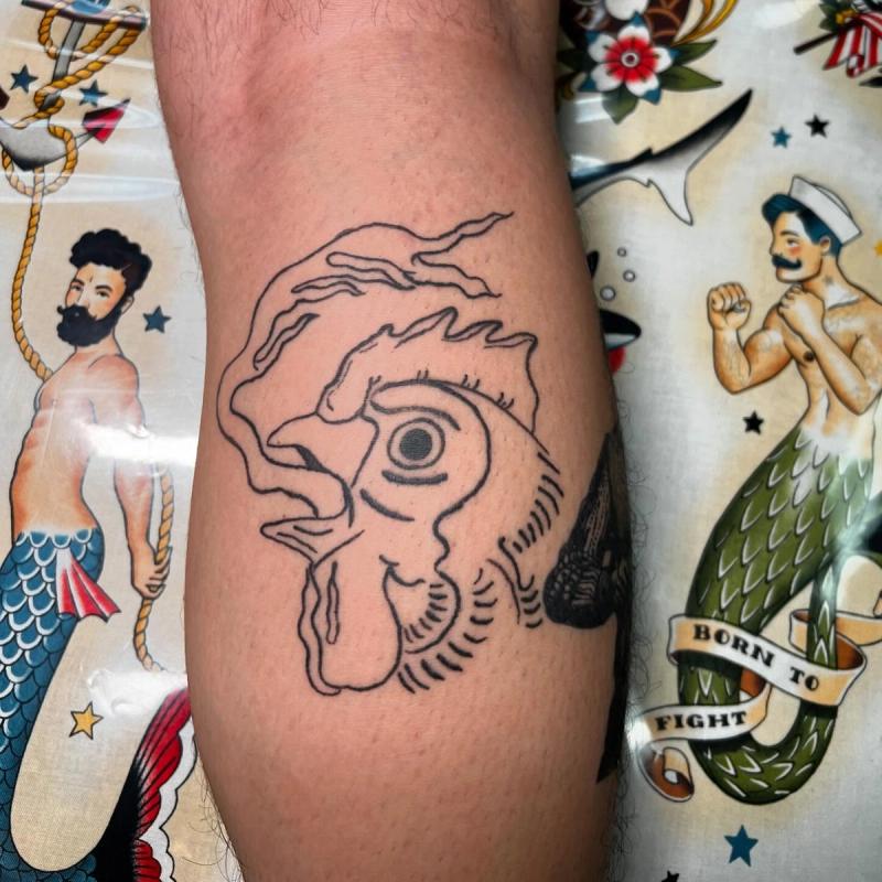 Blackwork outline of a rooster head on the forearm