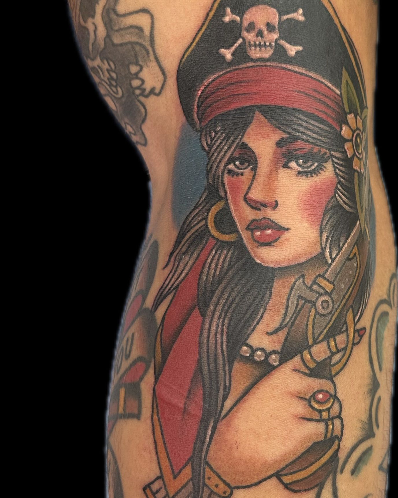 Colorful neo traditional pirate woman tattoo on upper arm