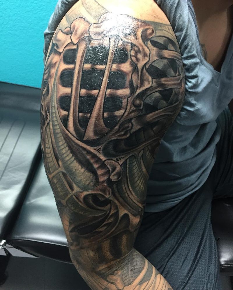 Black and grey biomechanical ribcage full sleeve on arm