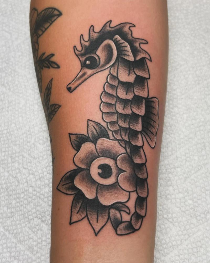 Black and grey traditional seahorse tattoo on forearm