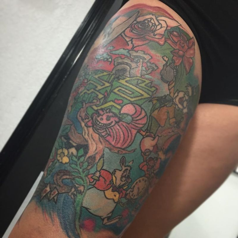 colorful alice in wonderland tattoo on thigh