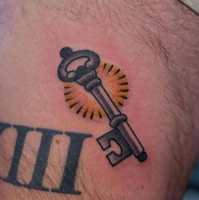 traditional key and numbers tattoo on thigh