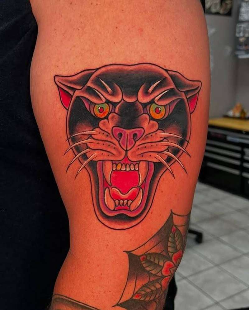 Colorful American Traditional panther tattoo on upper arm