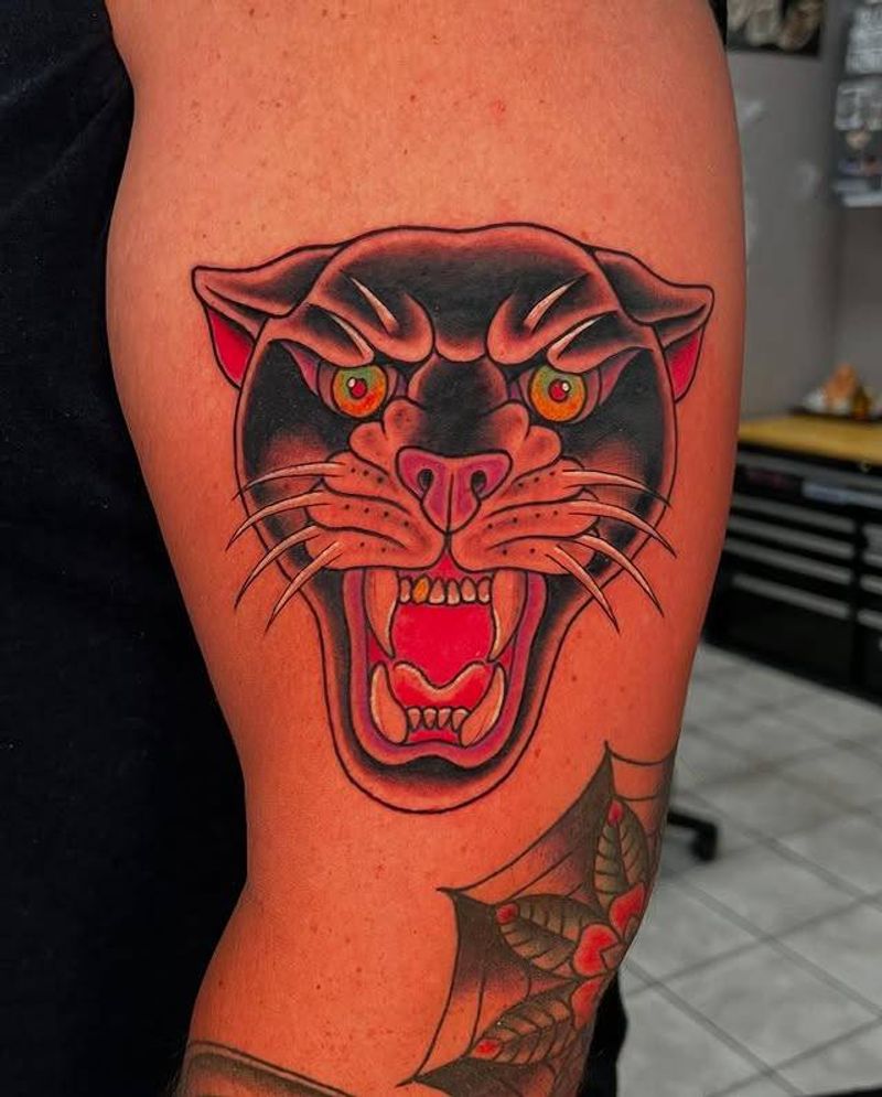 Colorful American Traditional panther tattoo on upper arm