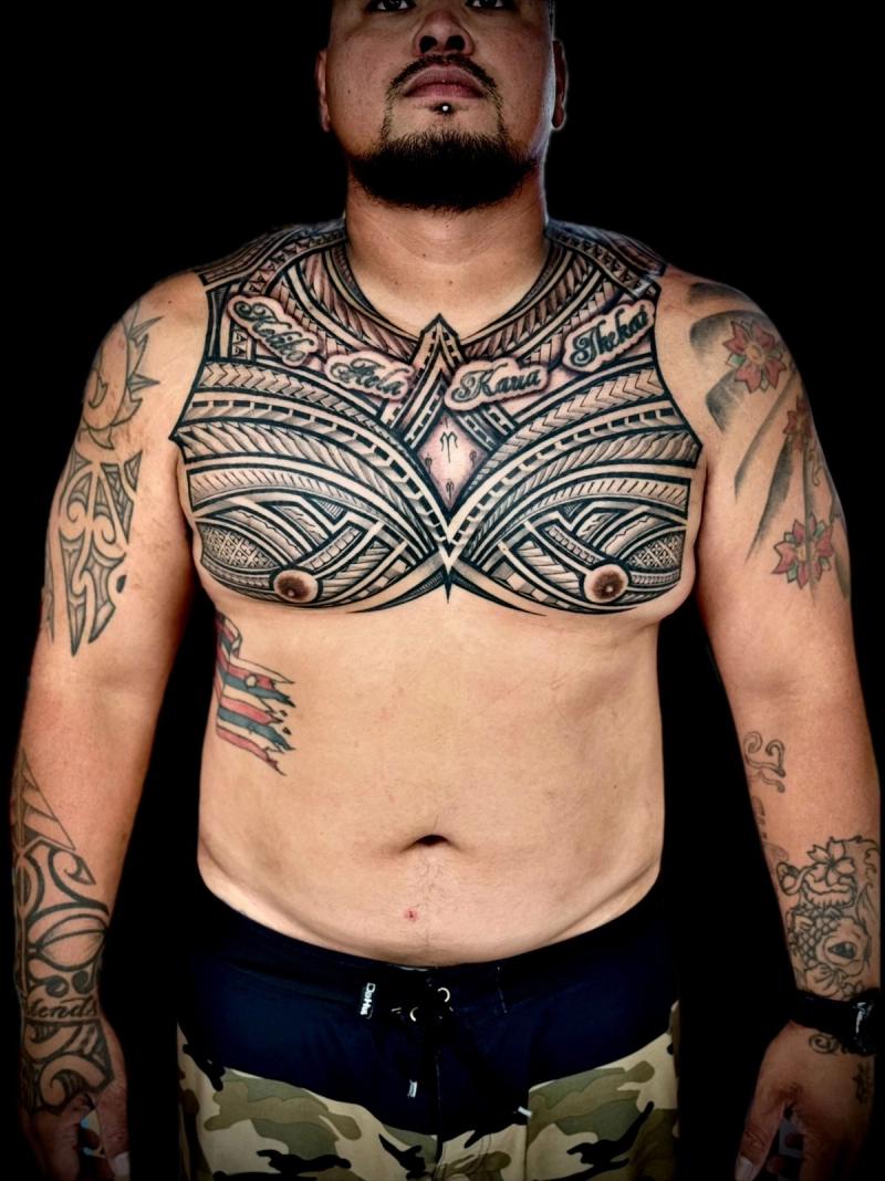 Tribal black and grey geometric tattoo covering full chest