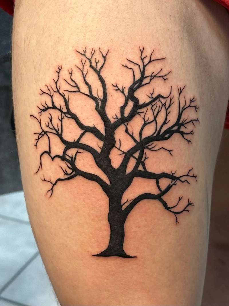 black tree silhouette tattoo on thigh