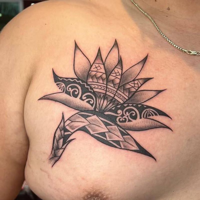 tribal geometric tattoo on chest with black and grey colors