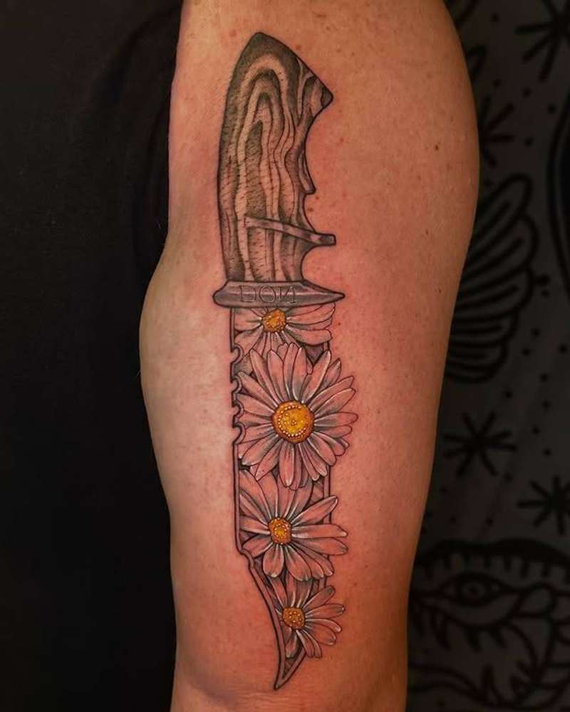 Black and grey knife with flowers on upper arm