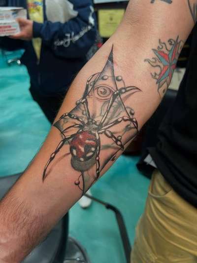 illustrative spider tattoo on forearm