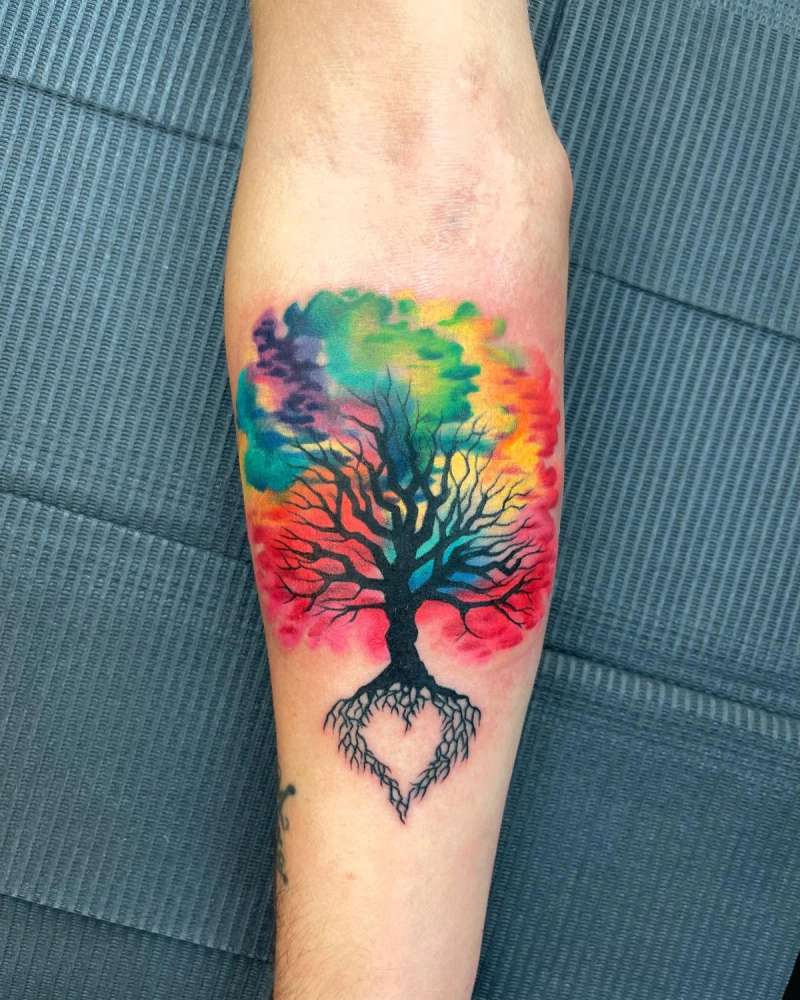 tree tattoo with colorful background on forearm